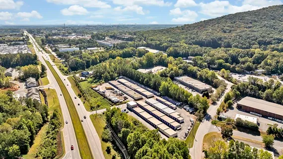 Aerial view of self storage facility located near major roadway with surrounding neighborhood
